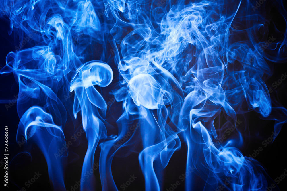 Fototapeta premium Blue artistic smoke on black background texture. 