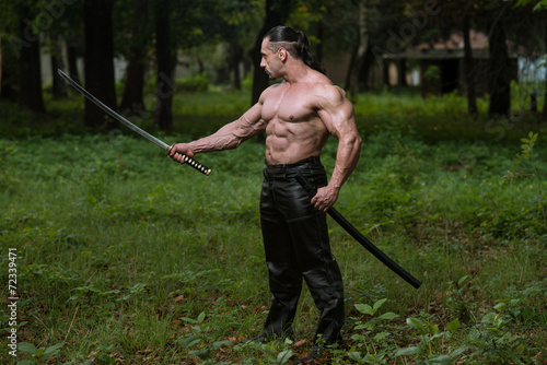 Muscular Man Holding Ancient Sword