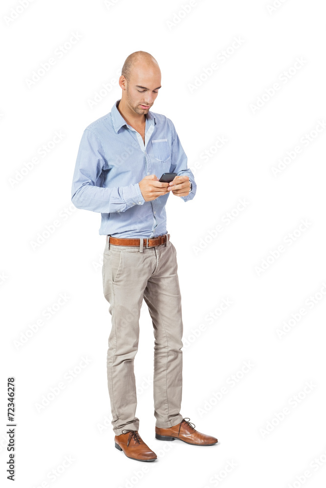 Handsome man reading a message on his mobile Handsome man reading a message on his mobile
