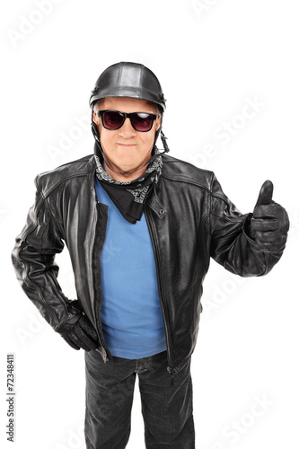Vertical shot of mature biker giving a thumb up