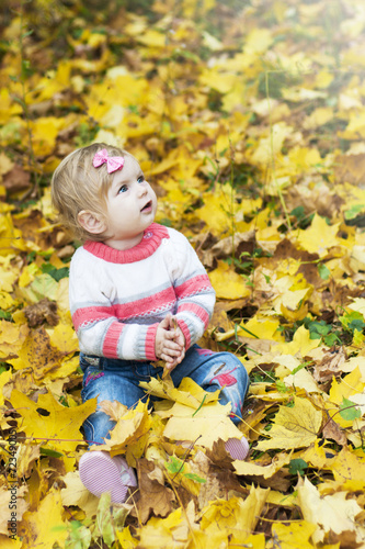 Baby girl with autumn leaves