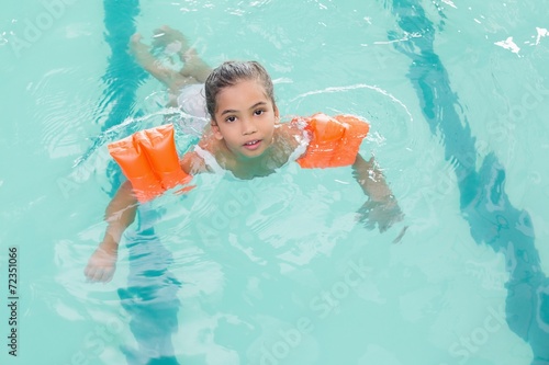 Cute little girl learning to swim