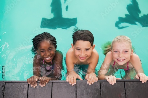 Schilderij op canvas Cute swimming class in pool with coach
