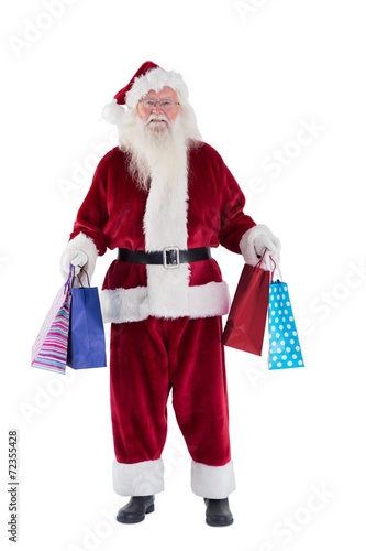 Santa carries some Christmas bags