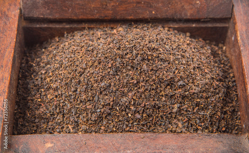 Dried, processed and blended tea leaves in wooden box