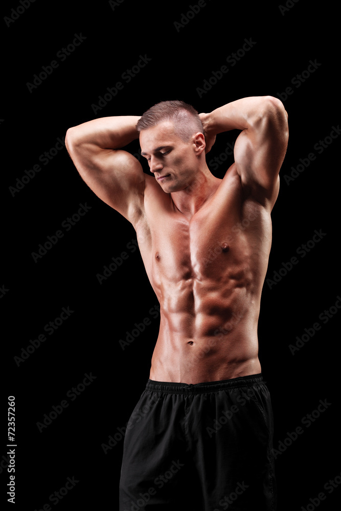 Handsome muscular guy posing on black background Handsome muscular guy posing on black background