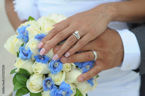 Wedding couple hands on flowers