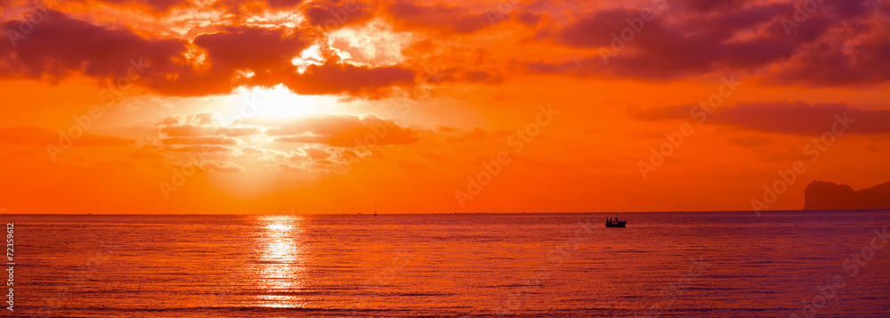 Fototapeta premium boat silhouette in an orange sunset
