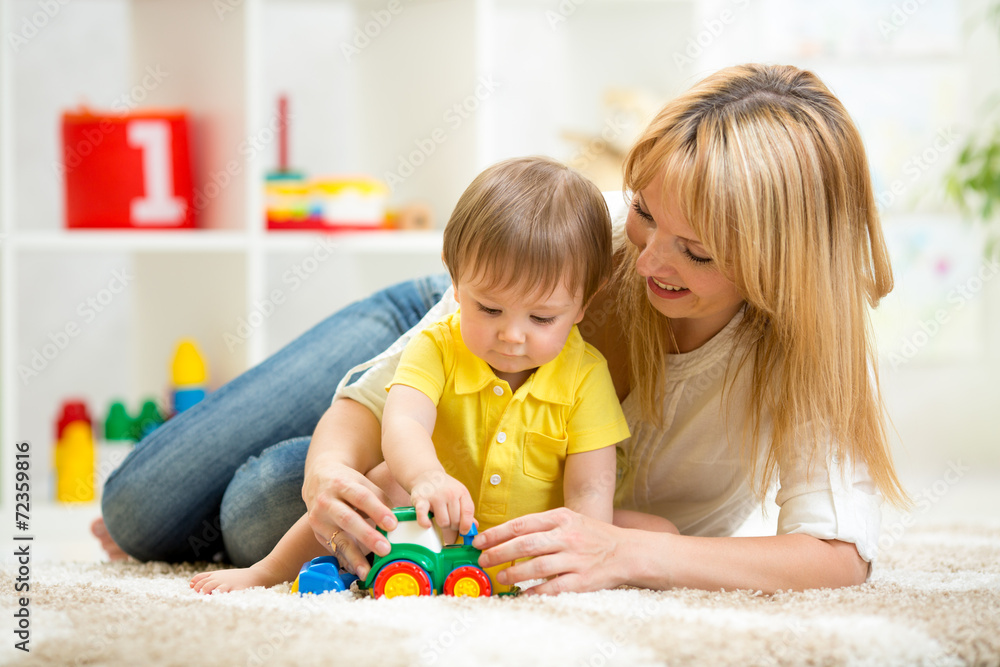 child boy and woman playing with toy indoor child boy and woman playing with toy indoor