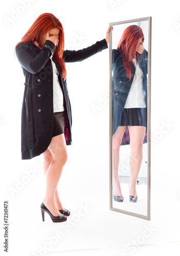 model isolated on plain background ashamed hiding face in hand