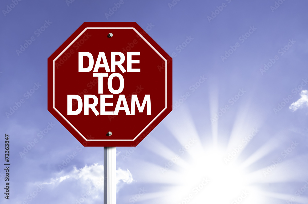 Dare to Dream written on red road sign Dare to Dream written on red road sign