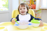 laughing 2 years toddler has dinner
