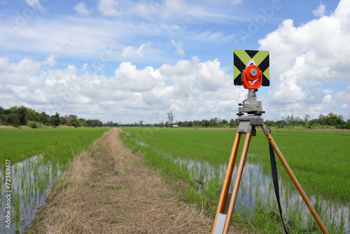 Survey instrument set on a tripod in the field