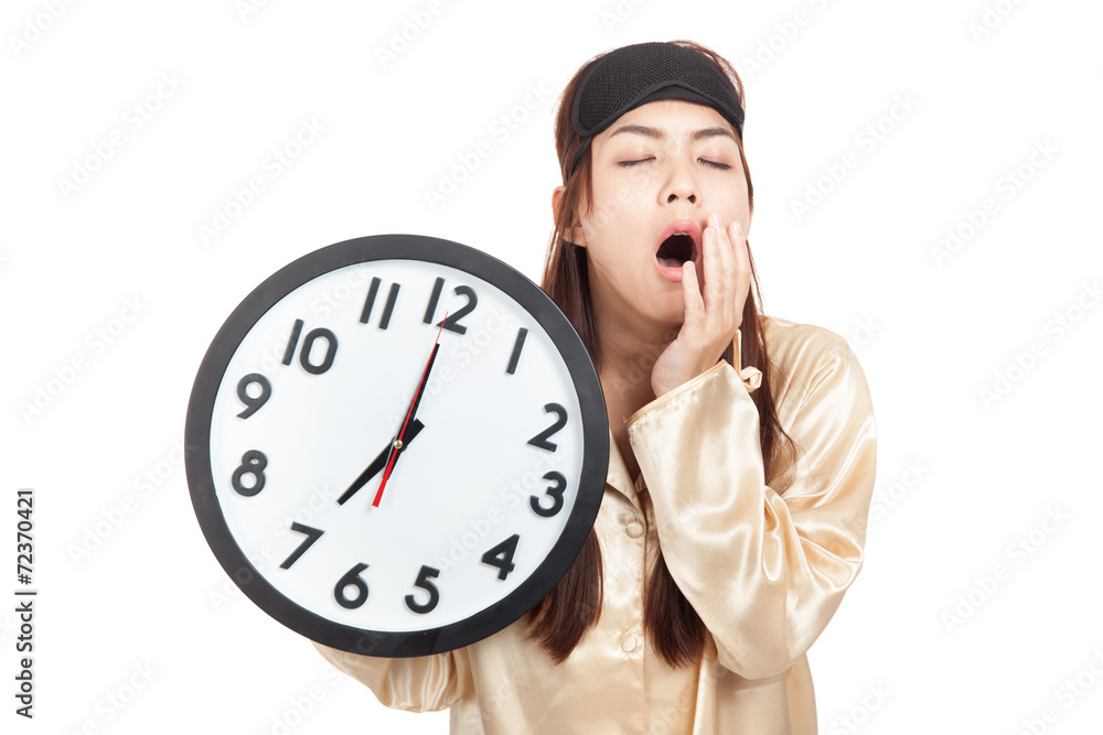 Sleepy Asian girl with eye mask hold a clock Sleepy Asian girl with eye mask hold a clock