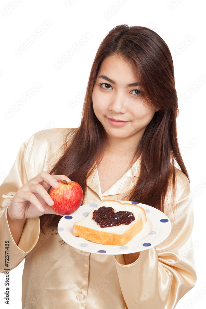 Asian woman with apple , bread and heart shape berry jam Asian woman with apple , bread and heart shape berry jam