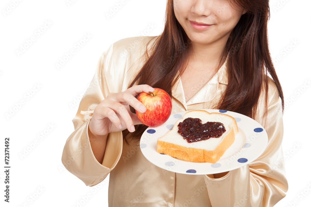 Asian woman with apple , bread and heart shape berry jam Asian woman with apple , bread and heart shape berry jam
