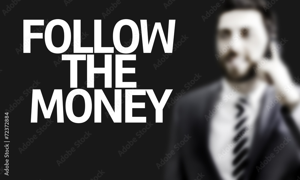 Business man with the text Follow the Money Business man with the text Follow the Money