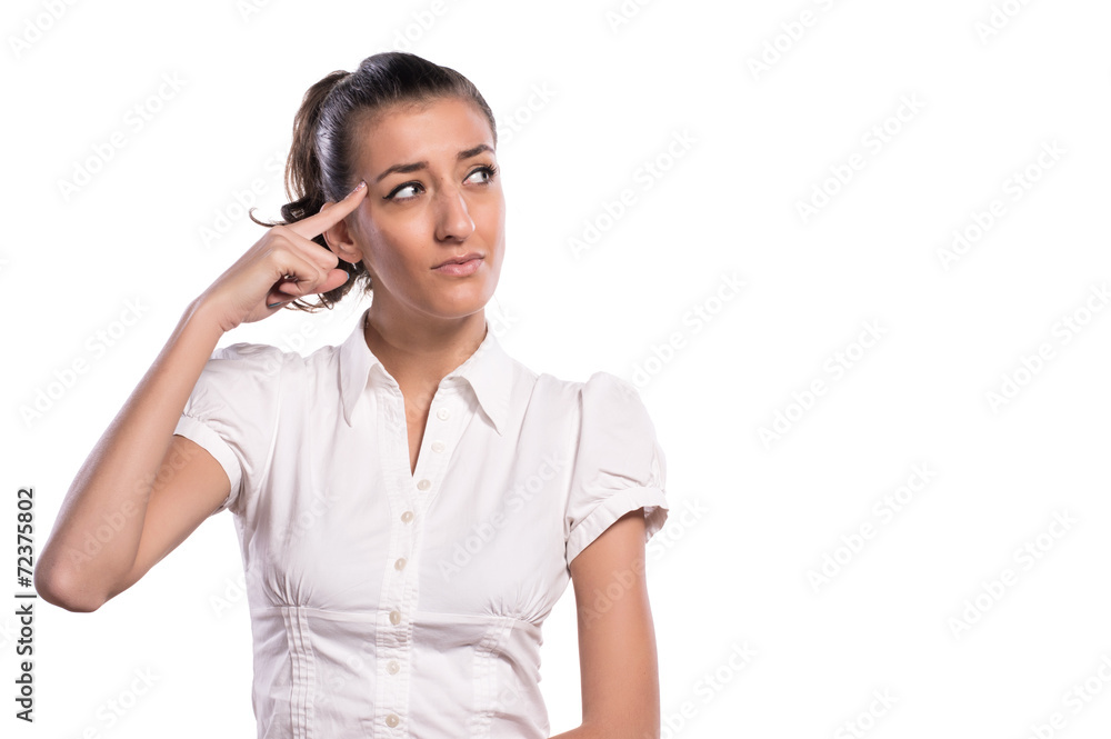 Attractive woman pointing finger to head on white background Attractive woman pointing finger to head on white background