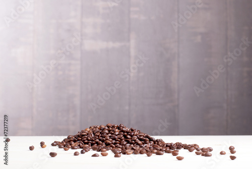 coffee beans on a wooden slide Lightstone table with dark backgr photo