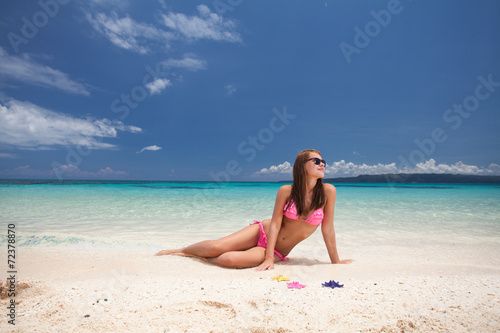 Beautiful girl sitting on the beach © Pavel Morozov
