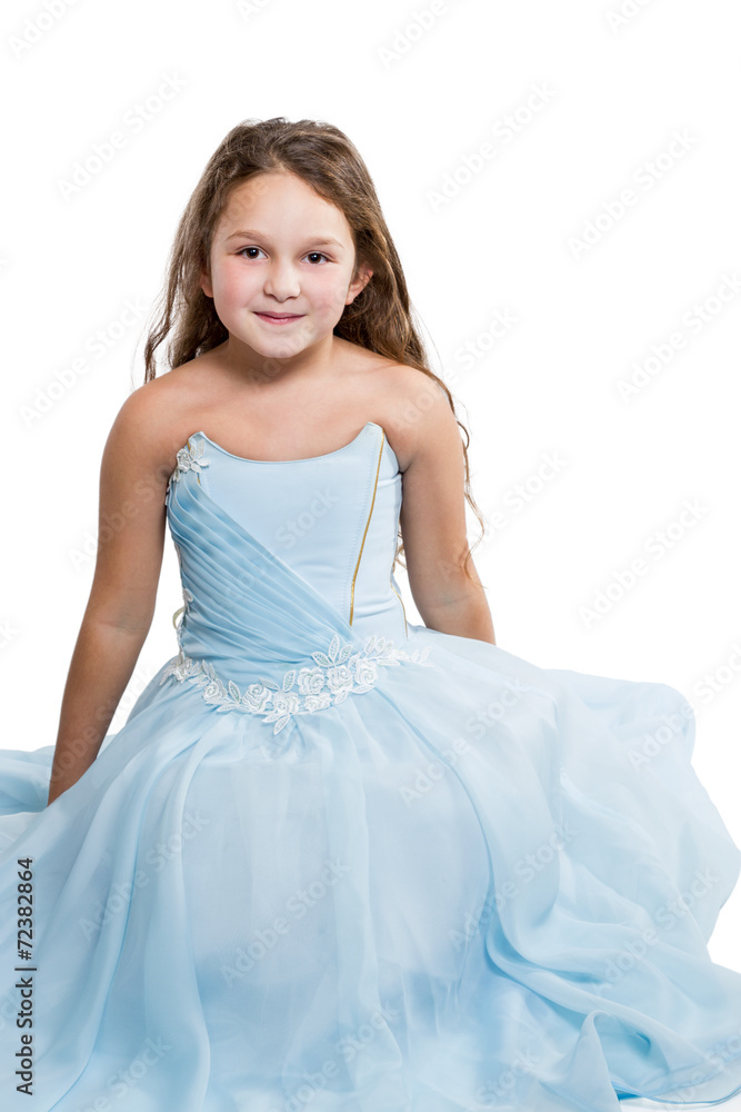 Girl in a blue dress sitting on the floor