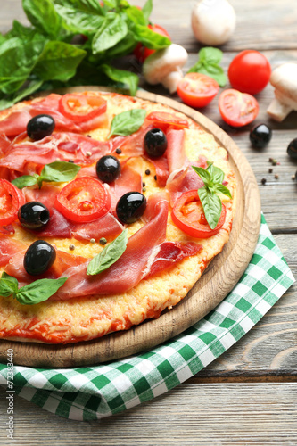 Delicious pizza served on wooden table