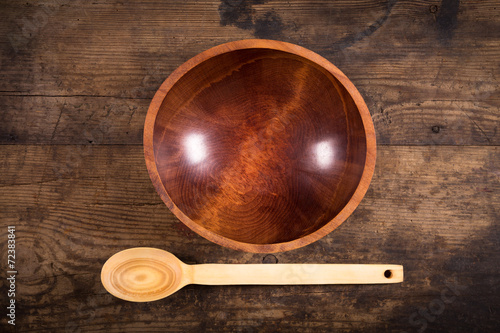 ladle and bowl on wooden background