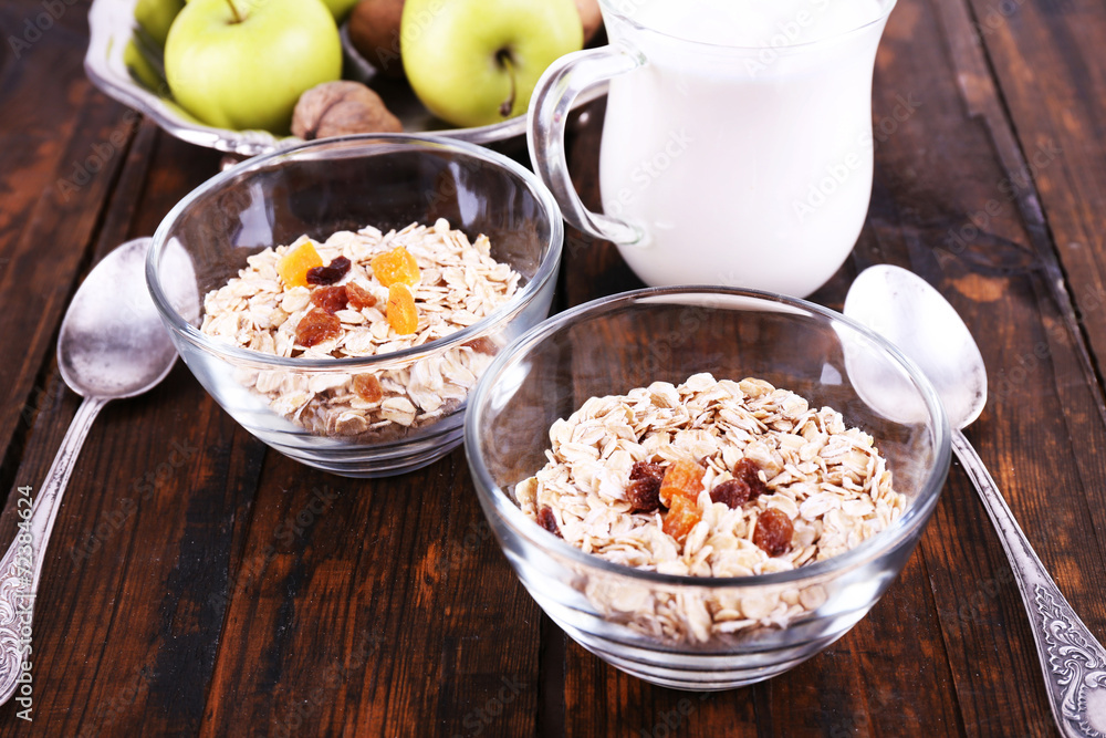 Oatmeal in bowls, yogurt, apples, dried apricots and walnuts Oatmeal in bowls, yogurt, apples, dried apricots and walnuts