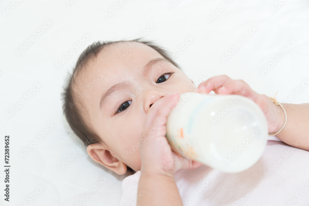 Asian baby infant eating milk from bottle Asian baby infant eating milk from bottle