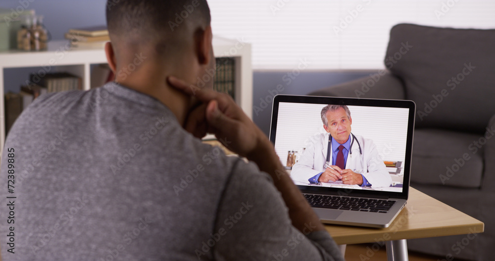Black patient talking to doctor on laptop