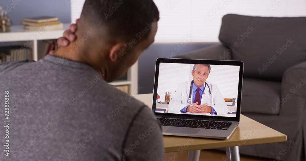 Black patient discussing health problems with doctor online Black patient discussing health problems with doctor online