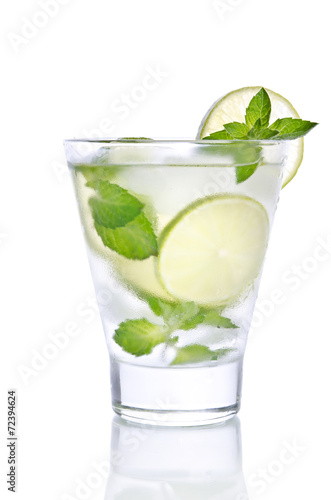 small glass with lemonade, ice, mint and lime. Isolated on white