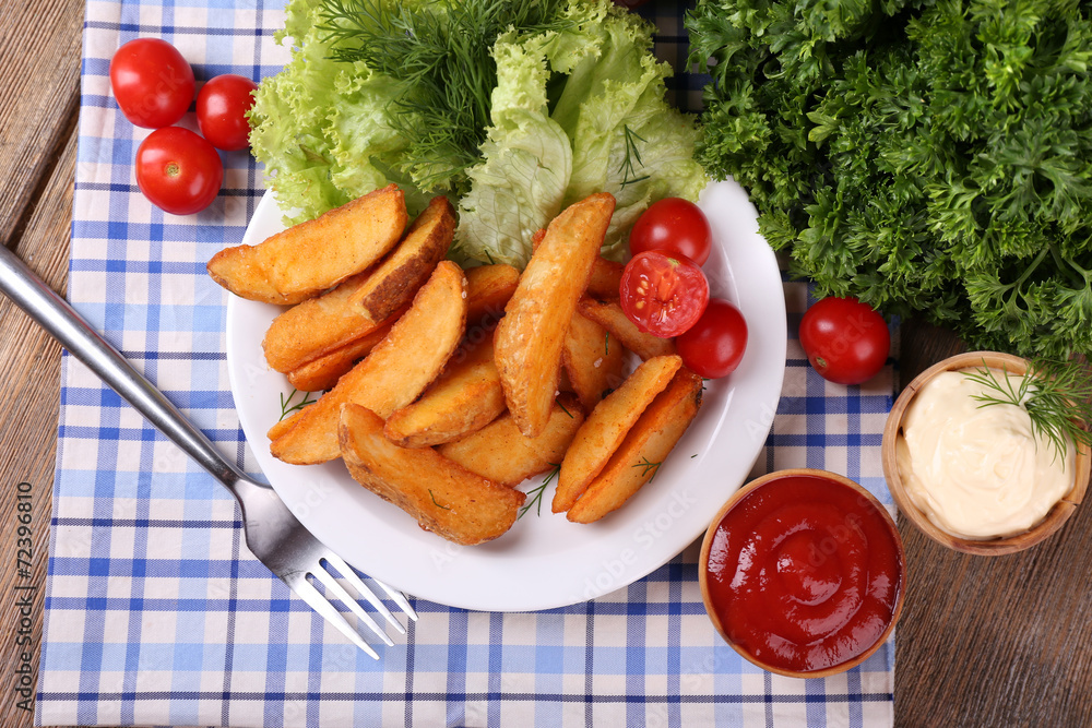 Homemade fried potato on plate on wooden background Homemade fried potato on plate on wooden background