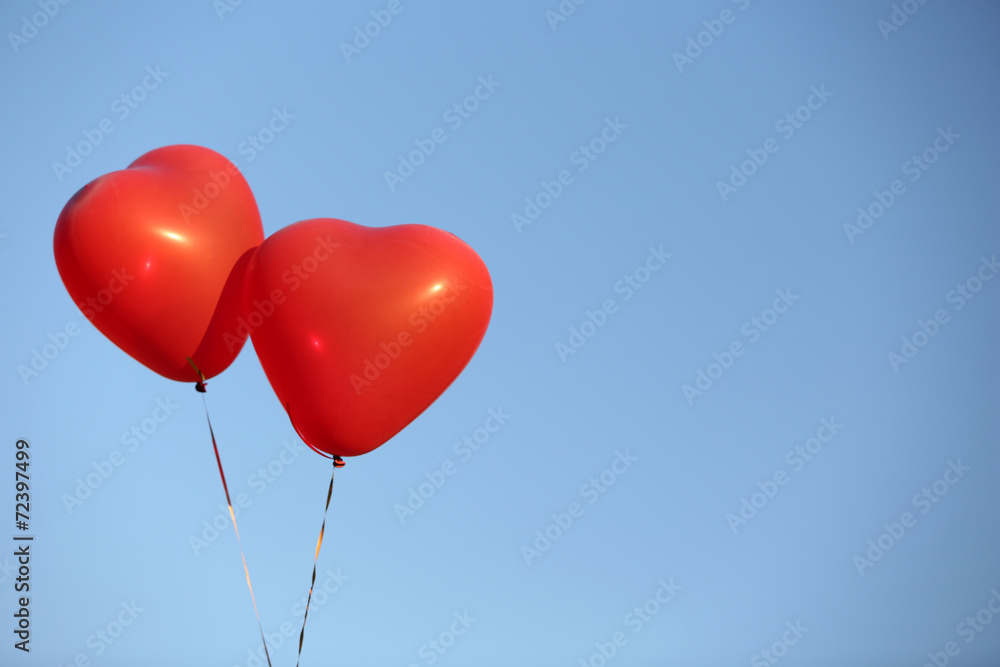 Love heart balloons on sky background