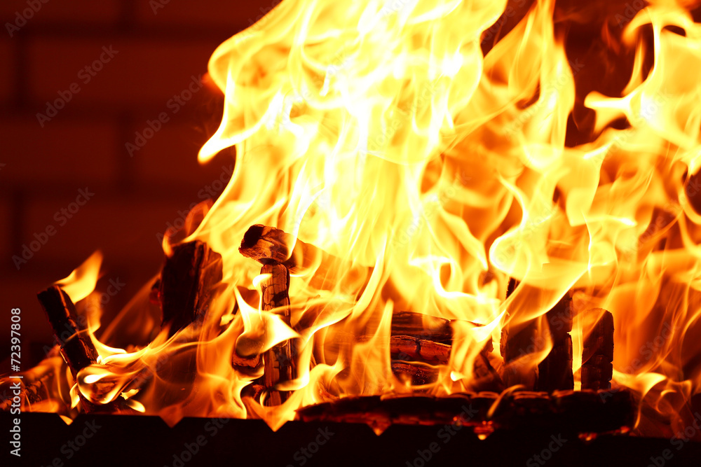 Bonfire at night on brick wall background Bonfire at night on brick wall background