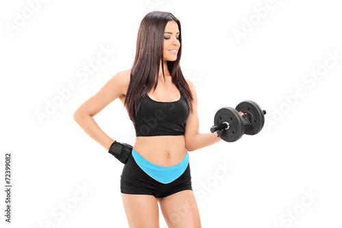 Young female athlete exercising with a barbell