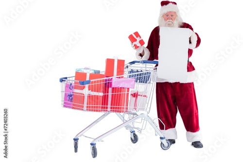 Santa spread presents with shopping cart © WavebreakmediaMicro