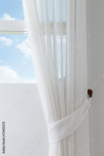 white curtain on the window with blue sky