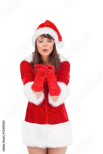 Sexy santa girl blowing over hands