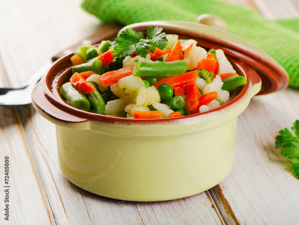 Mixed vegetables in a bowl on wooden table Mixed vegetables in a bowl on wooden table
