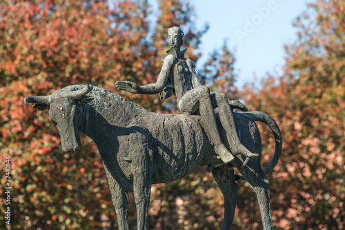 Statue of a naked man on bull in the downtown of Magdeburg, Germ