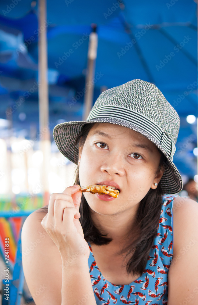 Woman eating seafood outside in summer smiling happy at camera. Woman eating seafood outside in summer smiling happy at camera.