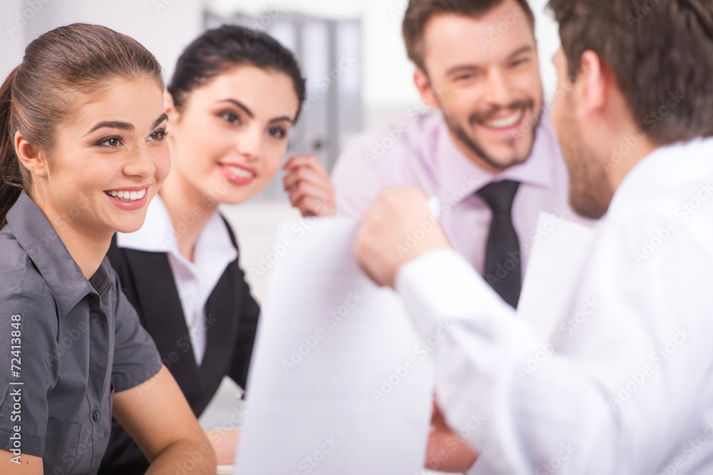 Group of young business people talking on business meeting. Group of young business people talking on business meeting.