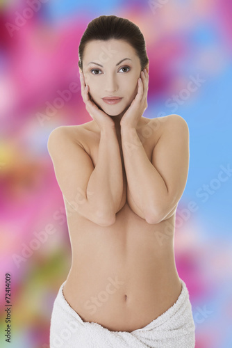 Nude woman covering her breast