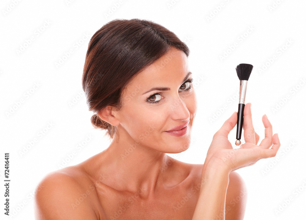Young latin woman with brush for smooth her face