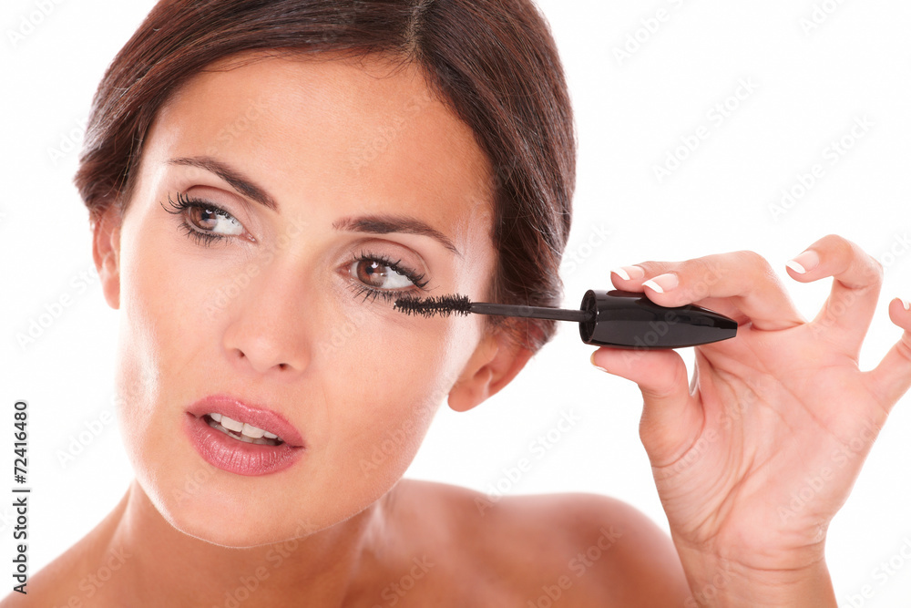 Sensual woman applying mascara to her eyelash Sensual woman applying mascara to her eyelash