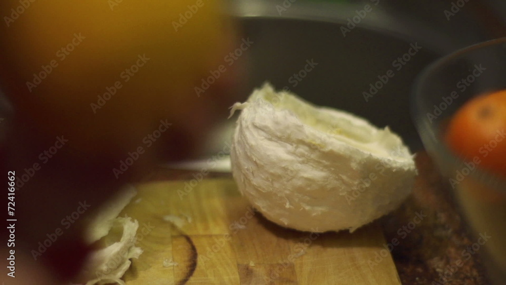 Woman peeling pomelo, closeup, steadycam shot, slow motion shot Woman peeling pomelo, closeup, steadycam shot, slow motion shot