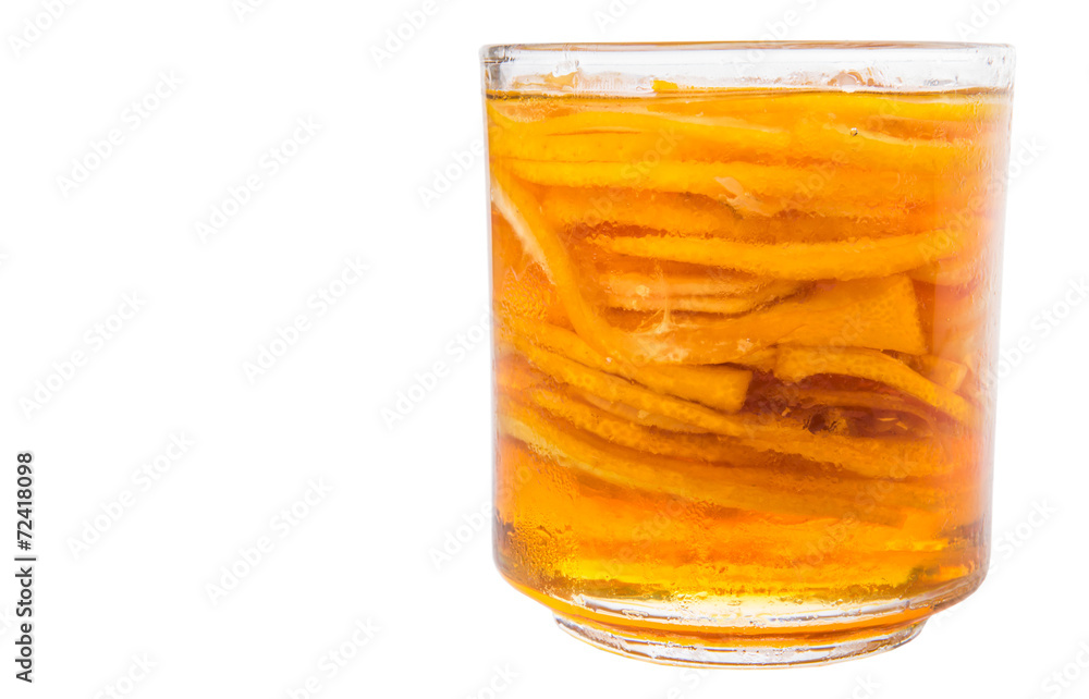 Home remedy of lemon slices and honey in a glass jar over white 