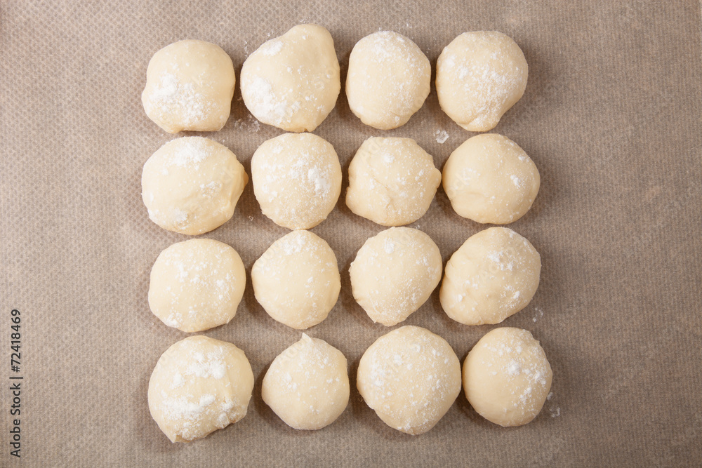 Small balls of dough with flour for pizza or cakes and scones on Small balls of dough with flour for pizza or cakes and scones on