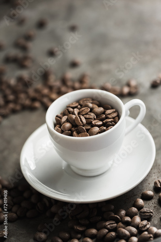 Roasted coffee beans with coffee cup